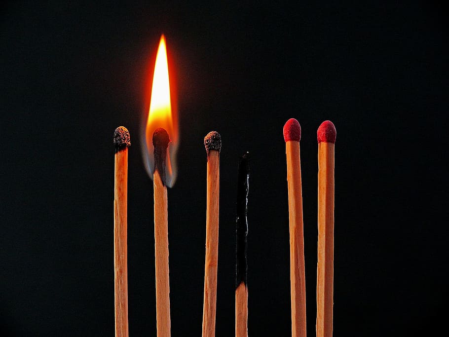 A match burns next to others, some of which are also burned.